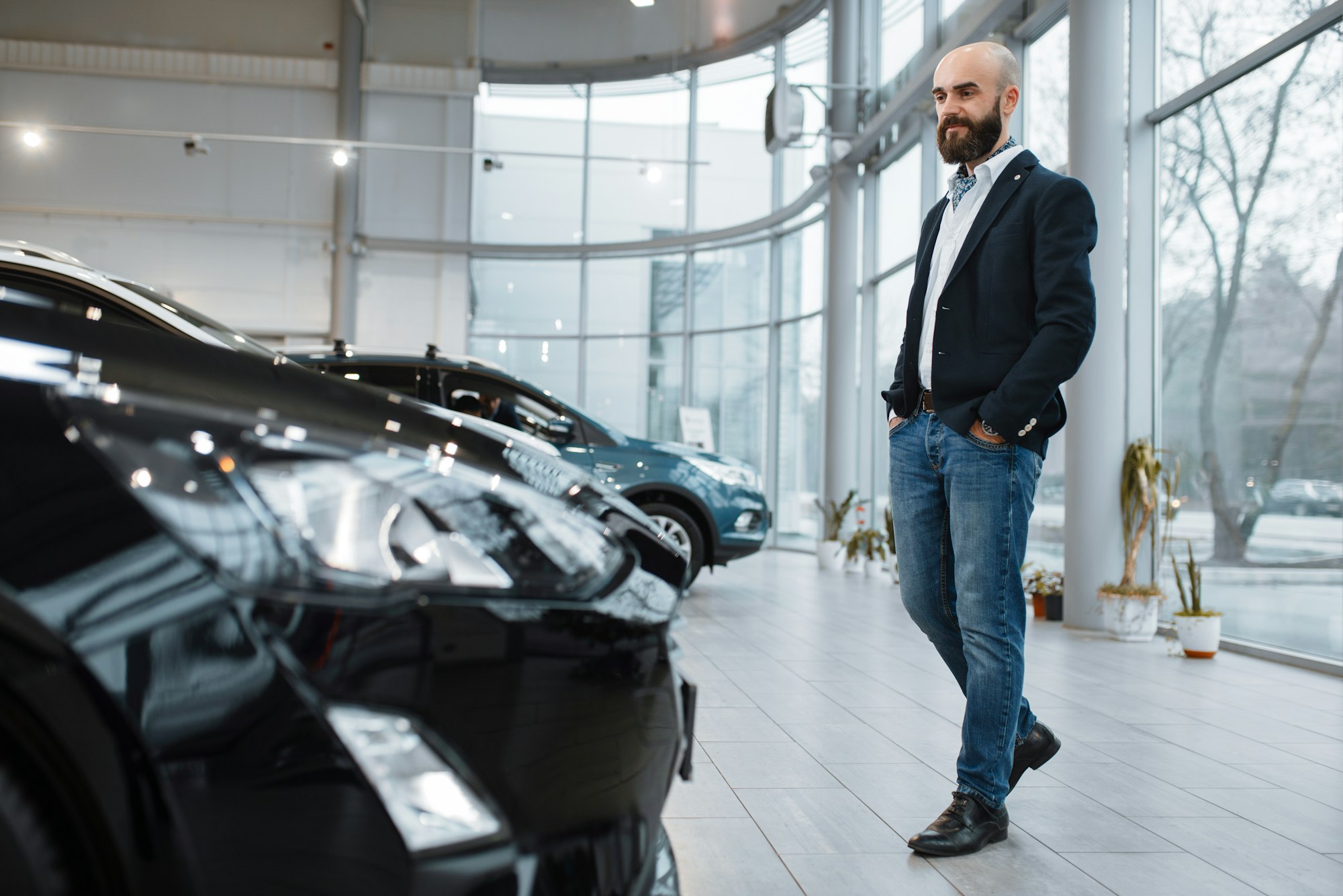 Businessman choosing transport in car dealership
